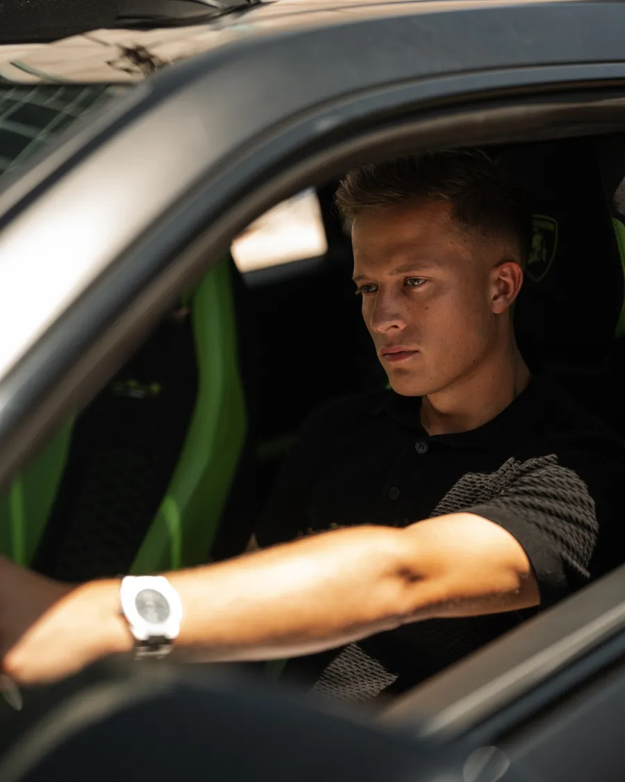 Torin sitting in a sports car